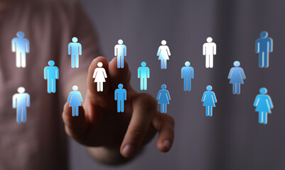 Hand reaching out to digital icons of people, symbolizing community, teamwork, and human interaction. Ideal for concepts of networking and conne