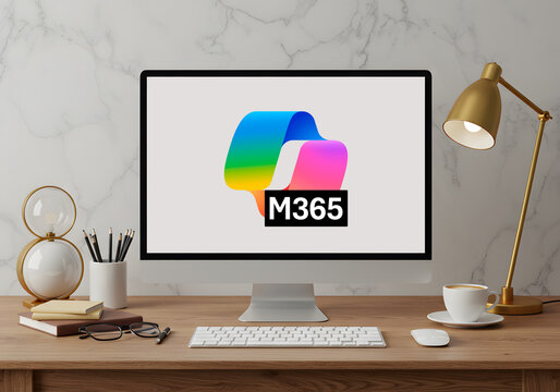 Microsoft 365 logo on computer monitor at office desk