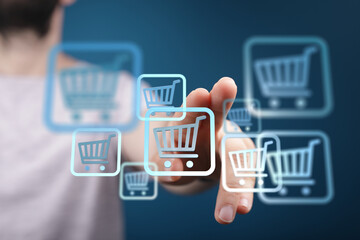 A person's hand interacting with virtual shopping cart icons. Concept of online retail, e-commerce, and digital shopping experience.