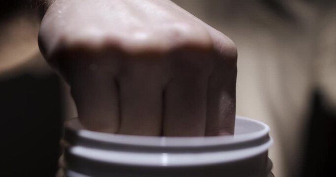 Protein powder in the measuring scoop in slow motion. Whey sports nutrition. Food supplement, bodybuilding, fitness and gym lifestyle. Dry mixture for preparation of sporting or dietary drink.  