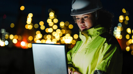 An energy professional ensures continuous 24 7 operations at a refinery. She uses digital...