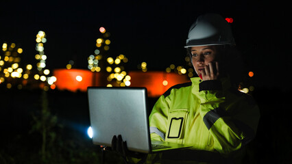 An energy professional ensures continuous 24 7 operations at a refinery. She uses digital technology to monitor sustainable production during the night shift.