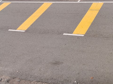 Bright Yellow Road Markings on Asphalt Surface