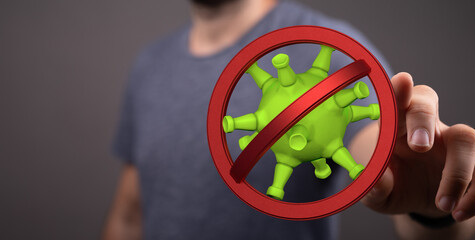 Concept of stopping coronavirus. Symbol of prohibition placed over virus by hand. Protection...