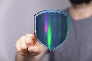 A person touching a digital shield concept, symbolizing protection, security, and safety online. Representing cyber security, privacy