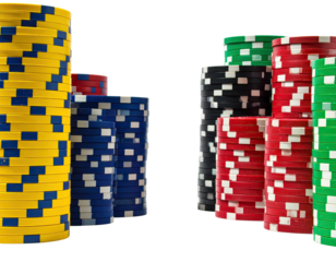 Colorful casino chips stacked high on a dark background, showcasing various color combinations