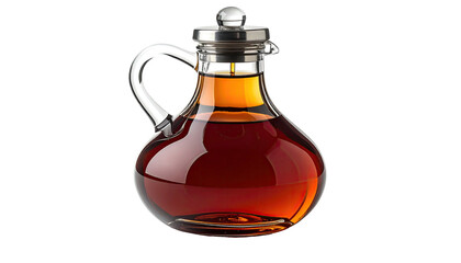 A glass pitcher containing a rich, amber liquid with a silver lid, isolated on black