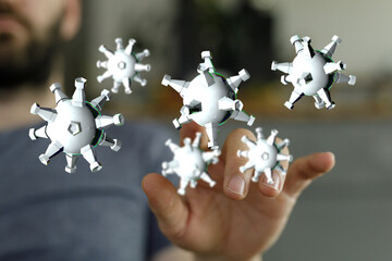 Abstract image showing a hand interacting with floating 3D virus models. Concept of health, science and techno