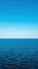 Fototapeta premium Deep blue water stretching to the horizon under a bright sky, illustrating the vastness and serenity found in large aquatic environments, water, aquatic, background