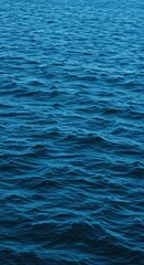 Fototapeta premium Deep blue ocean water texture showing movement across the surface. The vast saline liquid is clean, clear, and essential to marine life, transparent, essential, natural