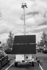 black and white image of a security trailer in a parking lot