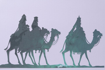 simplified paper silhouettes of the Three Wise Men on textured paper