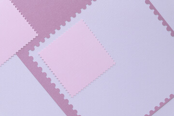 pink paper geometric shapes with perforated edges on blank paper