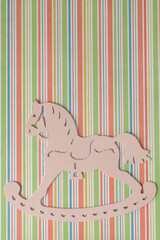 rocking horse silhouette shape on retro striped paper