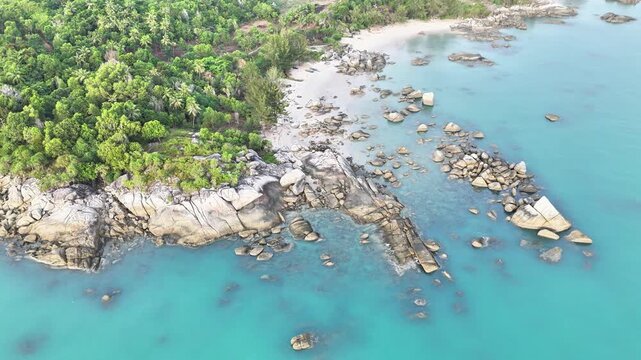 Exotic Coastal Landscape with Granite Boulders, Sandy Beach, and Clear Ocean