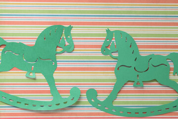 green paper rocking horses on striped paper