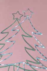 two holiday tree outlines with stars on blank paper