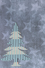 stylized paper tree machine-cut from contemporary scrapbooking paper featuring geometric stripe pattern, on paper with stars
