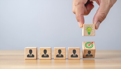 Hand placing light bulb idea cube on top of target cube, representing innovation and success in business
