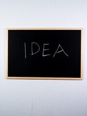 Chalkboard showing IDEA concept written vertically representing creative thinking and new ideas