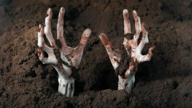 Eerie pale hands covered in dark soil emerge from the ground, depicting a macabre awakening