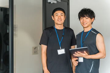 Sports gym, trainer in training gym, male instructor staff