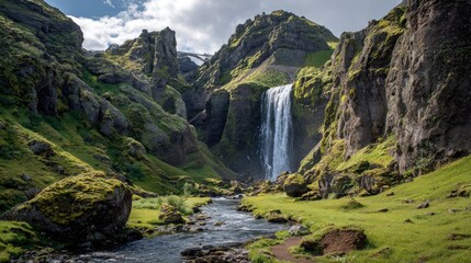 Majestic Waterfall Flowing Through Green Rocky Mountain Valley