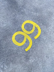 Yellow Marking on Gray Concrete Surface with Unique Curvy Design