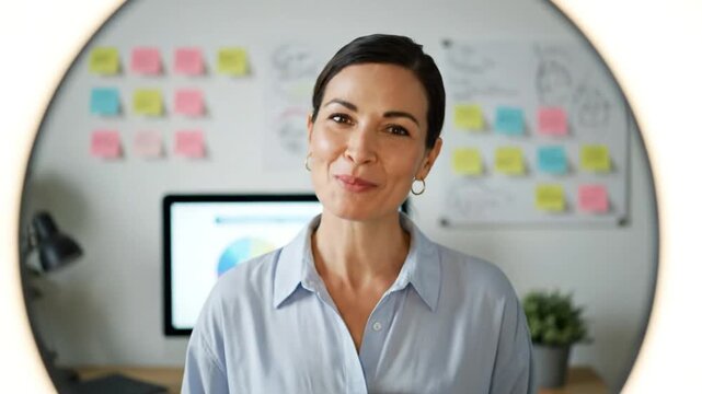 Confident female professional leading strategy in a modern office, showcasing project planning and business analytics for successful team collaboration and innovation