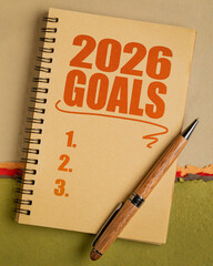 2026 goals list in a notebook with pen, setting New Year goals and resolutions