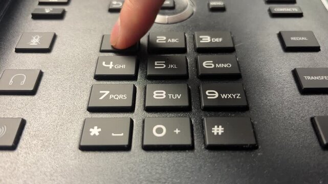 Slow Motion Close-Up of Index Finger Dialing 9-1-1 on Push-Button Phone