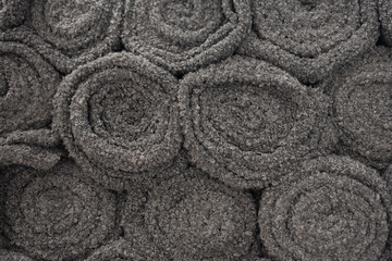 Grey wool fabric texture with circular swirl patterns. textile background featuring soft wool or sherpa material for fashion, interior design, or industrial concepts.