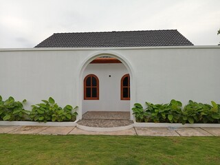 white building with curve door and grass like heritage building in Memayu Resort Yogyakarta