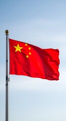 National flag of china waving on flagpole with blue sky outdoors