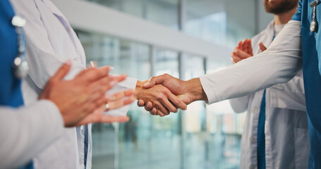Handshake, applause and doctors in hospital for agreement, support or medical deal together. Shaking hands, greeting and healthcare employees with welcome, collaboration or teamwork in clinic. © EineroLens/peopleimages.com