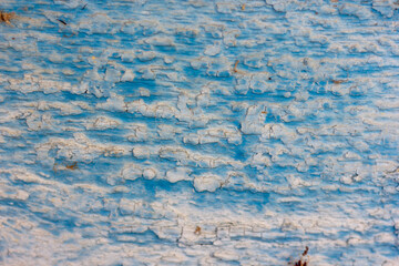 old wooden painted wall with cracked and sometimes peeling paint	