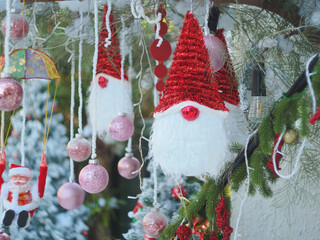 Santa Claus toy close-up on the background of a blurred Christmas tree