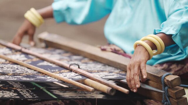 closeup, indonesian hand weaving on flores island, indonesia, slowmotion, culture and tradition