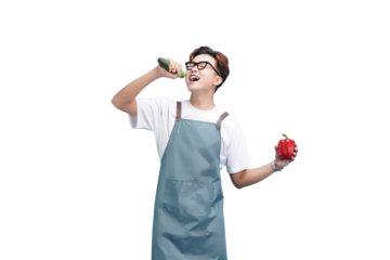 Culinary Caprice: A young chef with glasses playfully enjoys a vibrant moment while preparing fresh ingredients, embodying the joy and passion of cooking.