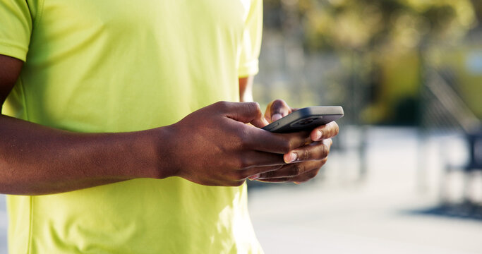 Fitness, phone and hands on court with typing, message update or exercise post on social media. Digital, man or athlete outdoor with mobile, wellness chat or virtual tutorial on training break - Powered by Adobe