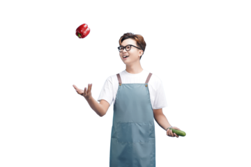 Joyful Juggle of Fresh Produce: A smiling individual, donned in an apron, joyfully juggles a tomato, showcasing a cucumber in another hand. The scene radiates freshness and vibrant activity.