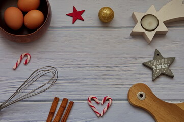 Ingredients for making Christmas cookies on a white wooden table