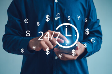 Businessman using smartphone with 24-7 clock and global currency icons for digital banking, nonstop financial service, fintech support, mobile payment, and real time online transactions.