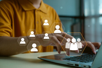 professional using laptop with virtual human network icons showing team connection, recruitment and workforce structure, representing digital HR management, online collaboration and staff analysis.