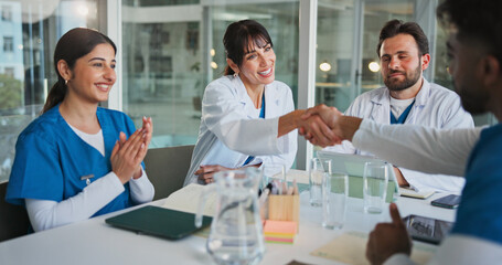 Hospital, teamwork and doctors with handshake in meeting for promotion, agreement and partnership....