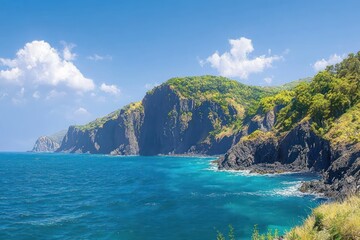 Rocky coastal cliffs with turquoise sea, lush green hills and waves under a clear blue sky with fluffy clouds, creating a serene and majestic atmosphere