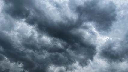 The dark sky with heavy clouds converging and a violent storm before the rain. Bad or moody weather sky and environment. carbon dioxide emissions, greenhouse effect, global warming, climate change. 