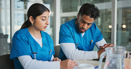 Obraz premium People, nurses and reading document in office for planning, medical results and patient history. Staff, team and review paperwork for referral letter, surgery schedule and information for healthcare