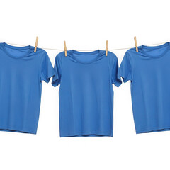 Three blue t-shirts hanging on clothespins isolated on transparent background