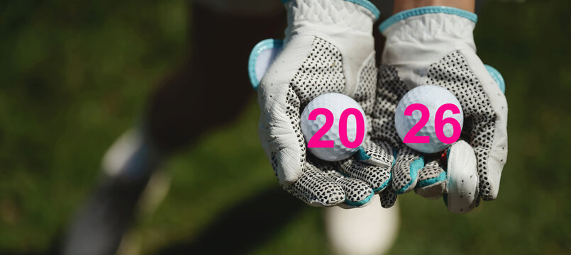 Closeup of golf gloves with two golf balls on green field - Powered by Adobe